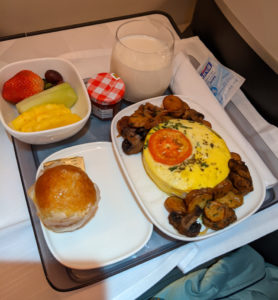 Breakfast on Delta: sausage quiche, fruit, ane a delicious chocolate pastry,...