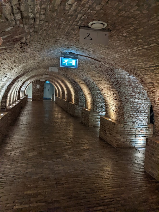 A long brick-lined corridor with a barrel-vaulted ceiling