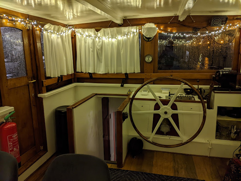 The wheelhouse.  Almost in the center is the boat's steering wheel; the stairs down to my room are on the left.
