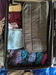 A tightly-packed suitcase. The CPAP case occupies most of it.