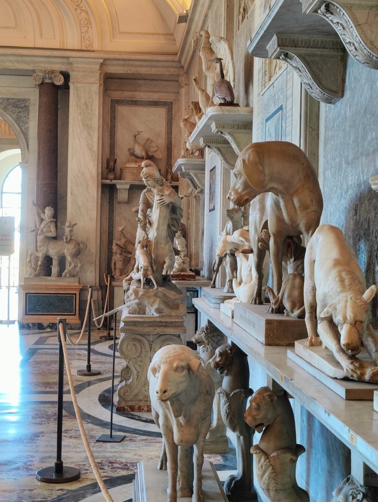 A hall with statues of animals along the right-hand wall