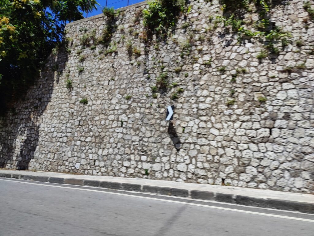 A wall made of roughly cut blocks of white stone.