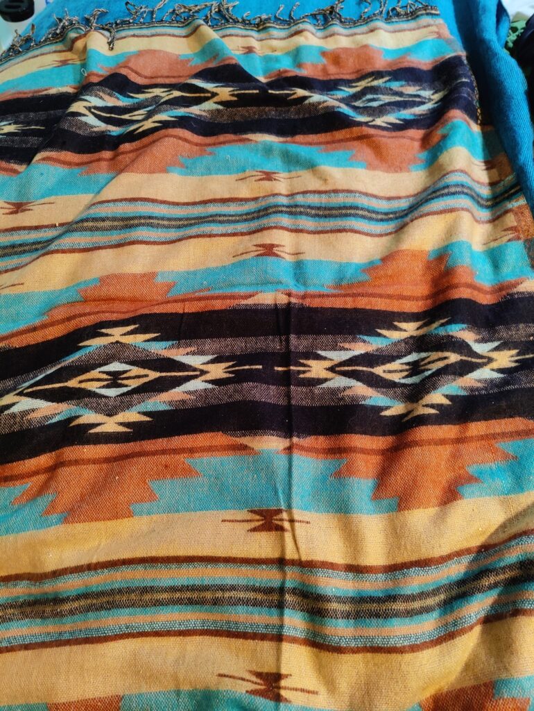 A Navajo blanket with stripes and diamonds