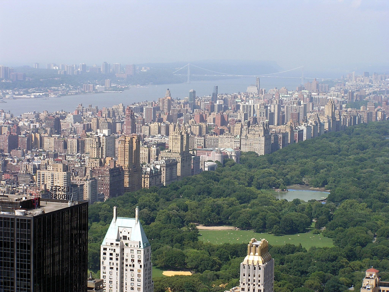 New York's Central Park occupies the lower right corner, with a few skyscrapers in the immediate foreground. The buildings of New York's Upper West Side are seen on the diagonal, with New Jersey in the upper left across the Hudson River.